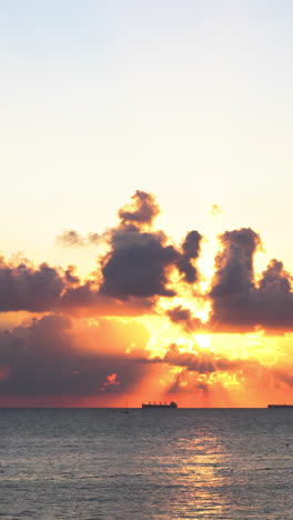 sunrise over the ocean with ships