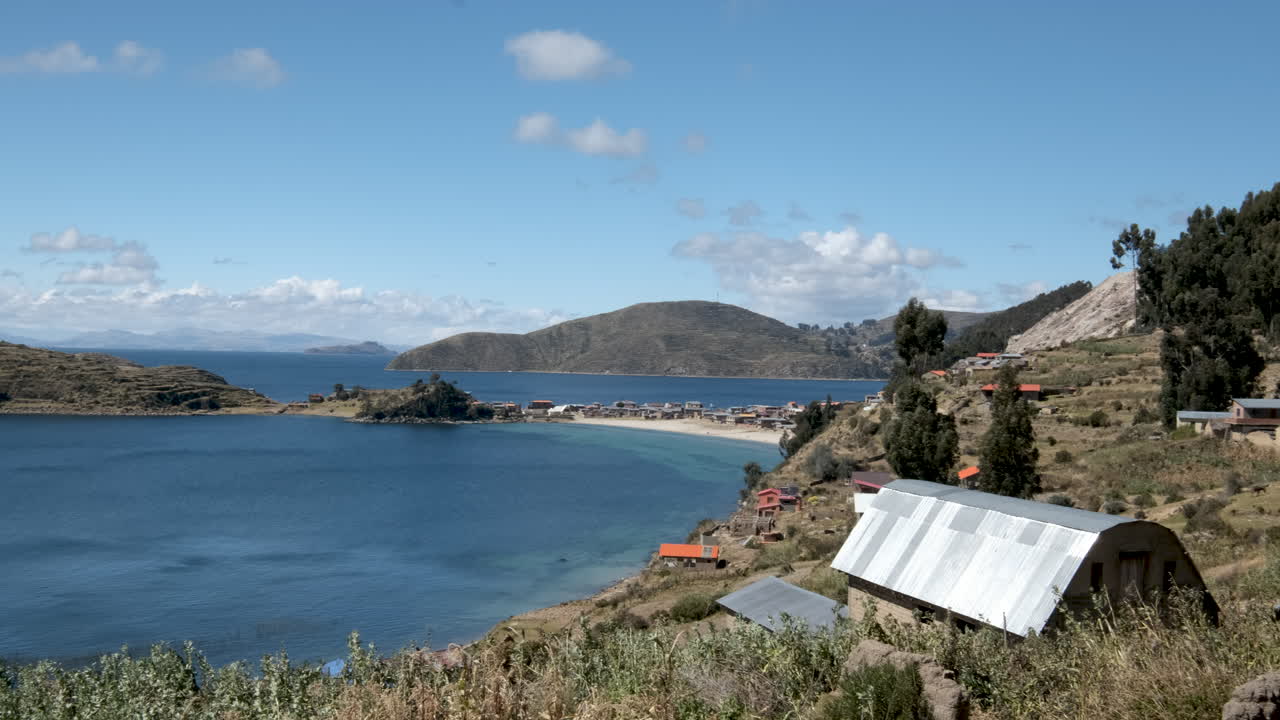 Pan shot of the Challpampa region on Isla del Sol, Copacabana, Bolivia. The serene lakeside landscape, traditional village, and tranquil beauty of this historic island on Lake Titicaca