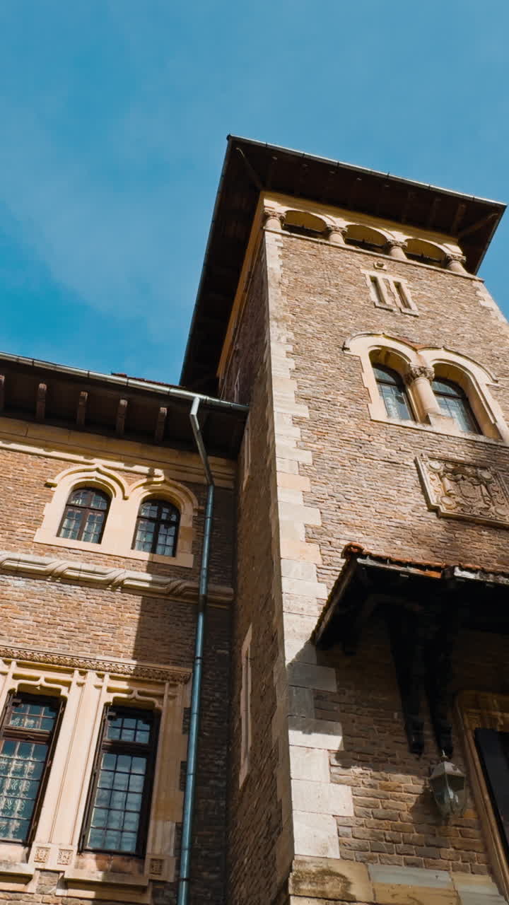 Entrance to Cantacuzino Castle in Busteni, Romania. Beautiful old building façade on sunny autumn day. Low angle view. Vertical video