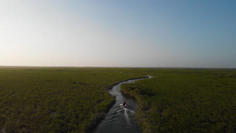 boat sailing in sian ka'an mexico mangrove ecosystem