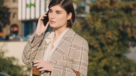 Mujer-Elegante-Haciendo-Una-Llamada-De-Negocios-Al-Aire-Libre.