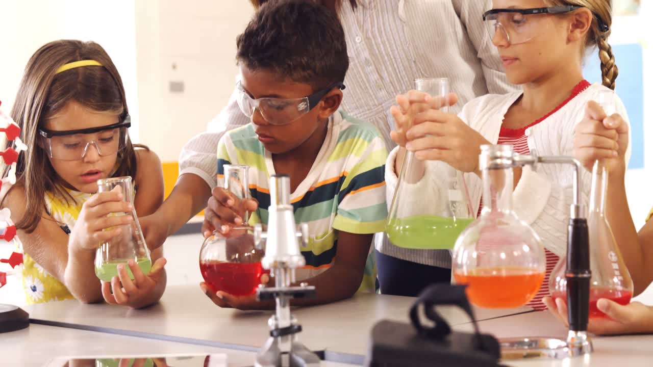 niños de la escuela haciendo un experimento químico en el laboratorio