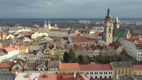 Aerial-Pan-of-Clock-Tower-and-Gothic-Cathedral-Surrounded-by-Buildings-in-Hradec-Kralove,-Czech-Republic