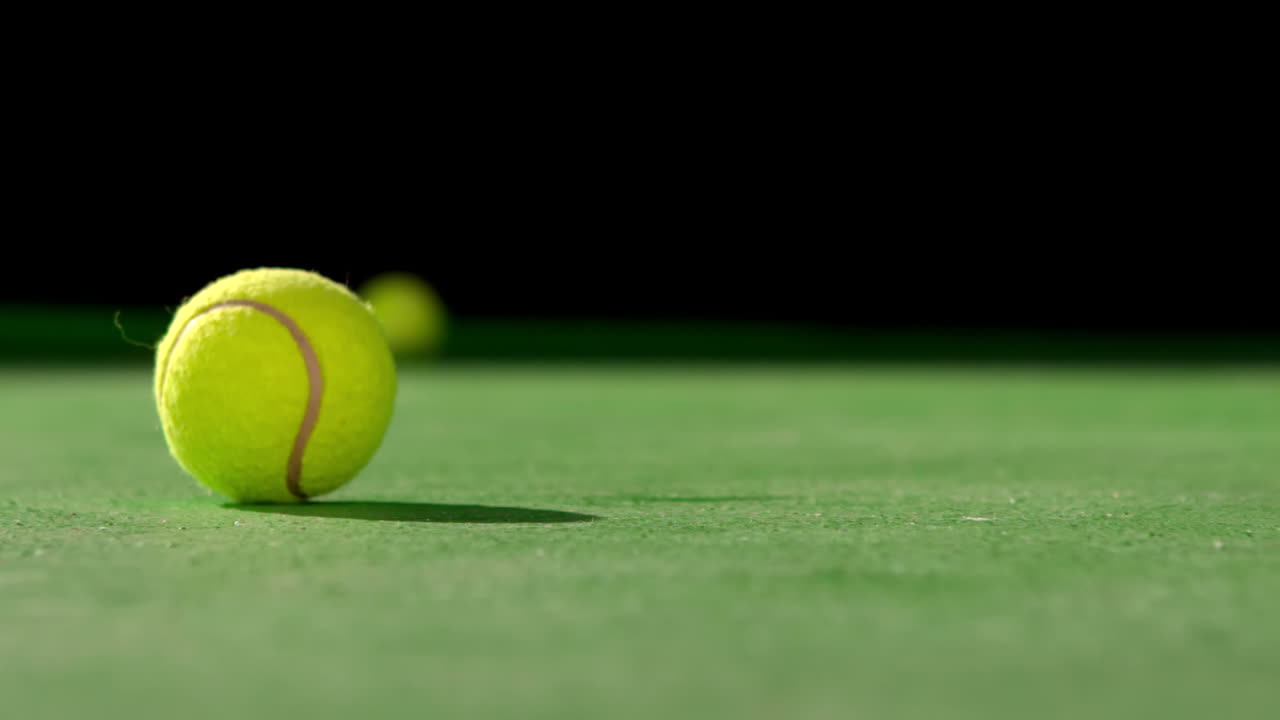 Premium stock video - Tennis ball rolling on surface