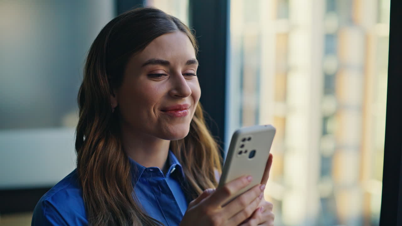 Joyful woman browsing smartphone message at living room closeup. Happy lady