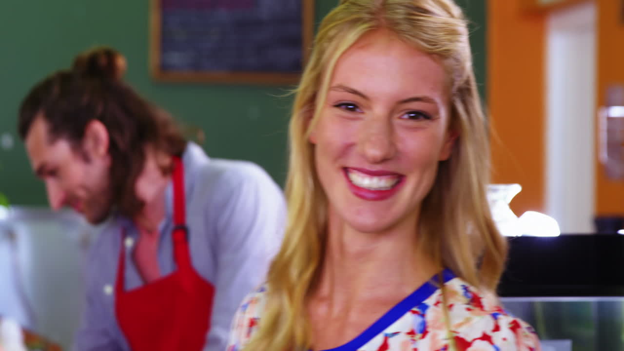 personal masculino dando café a una mujer en una cafetería