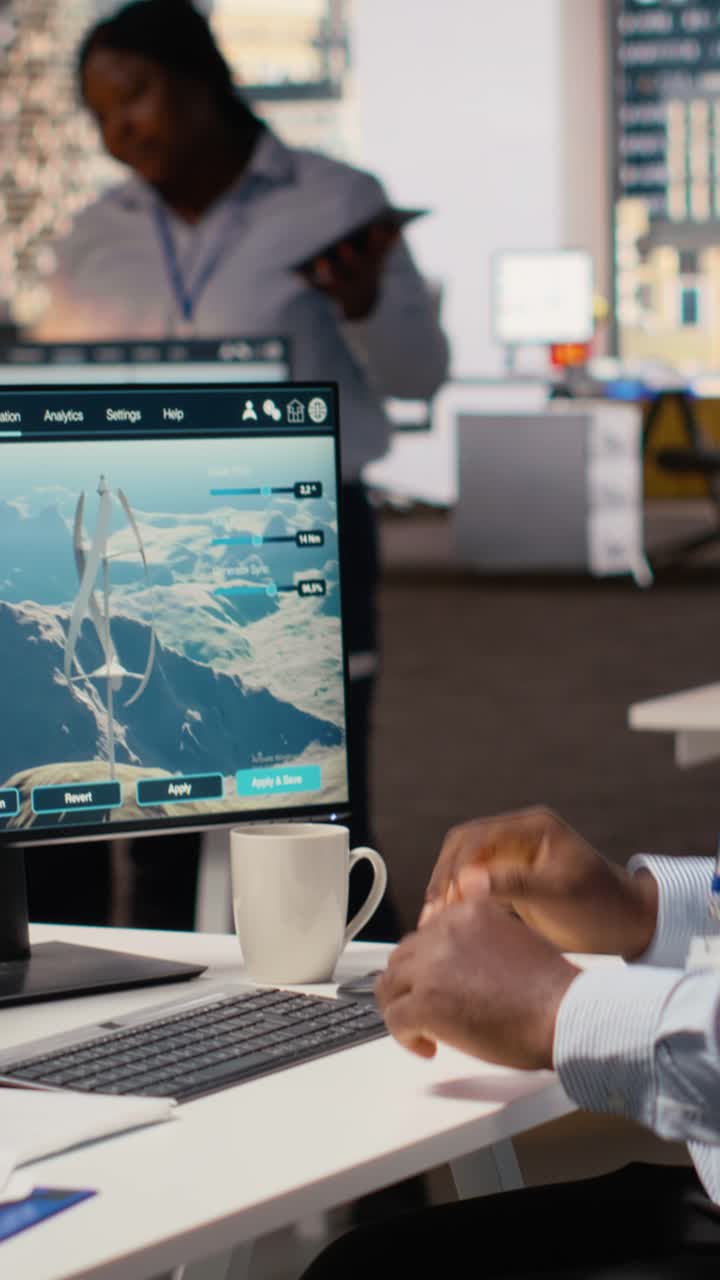 Worker enters office, uses electric grid and wind farm layout optimization tools