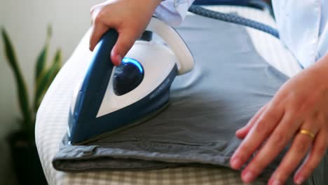 selective focus of women is ironing clothes and pants to use them throughout the week of work daily routine and holidays