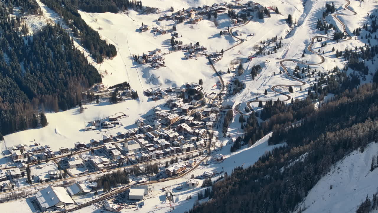 Aerial drone view of the Corvara village covered in snow, in South Tyrol, Dolomites, in northern Italy
