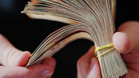 tightly bound euro cash fanned open in hand with focus on curve and texture