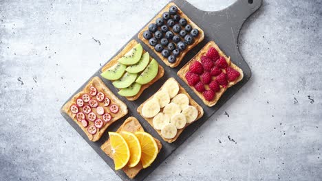 wholegrain bread slices with peanut butter and various fruits