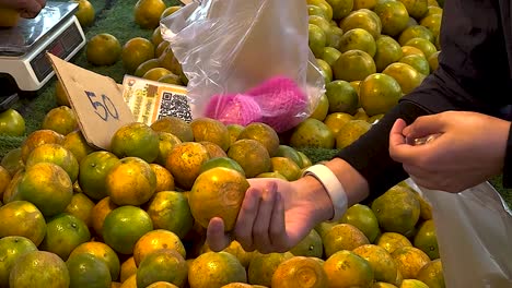 buying oranges at a market