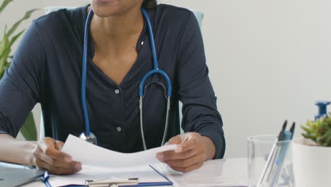 Mid-Section-Female-Doctor-Discussing-Results-With-Patient