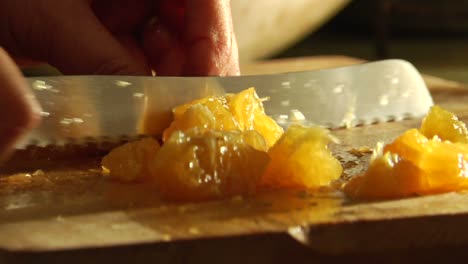 a woman slices an orange on a cutting board