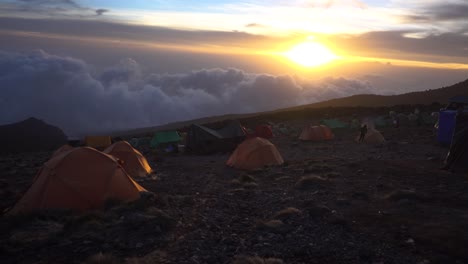 beautiful sunset at mount kilimanjaro tent camp with thick clouds