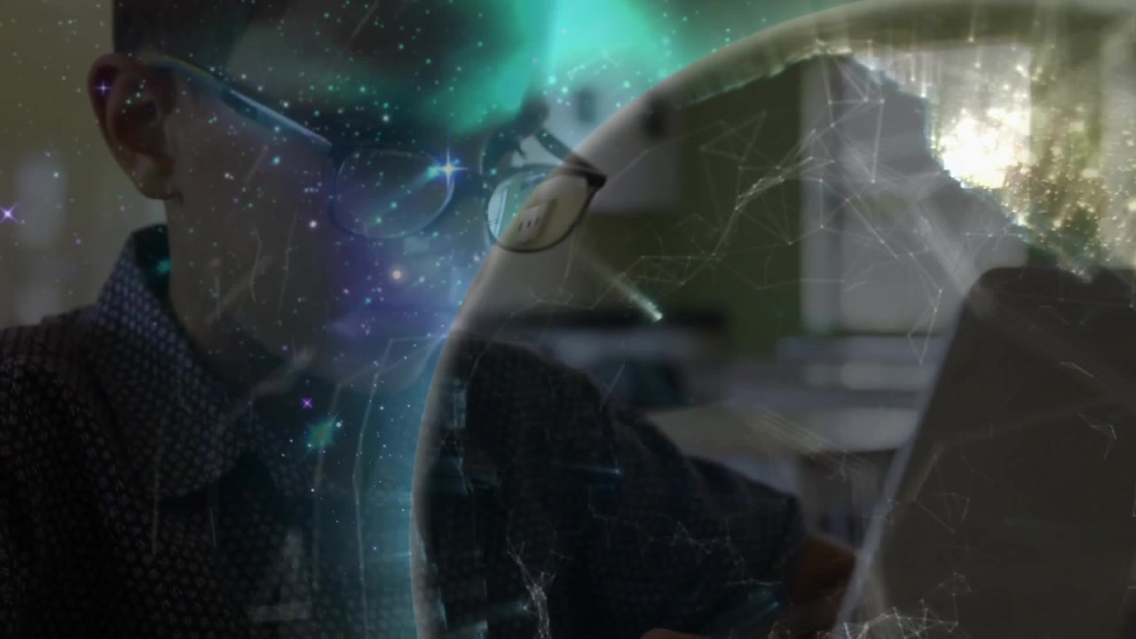 Child typing on laptop, initiating rotating globe overlay shifting across face for learning