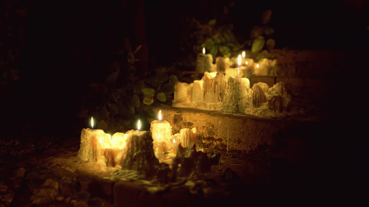Soft candlelight illuminates steps in a serene outdoor setting at night
