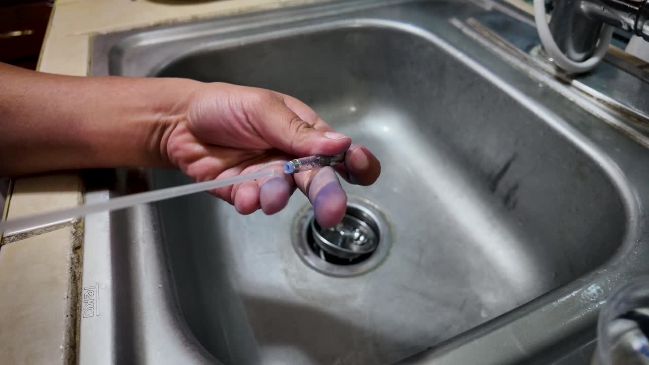 Close-up video shows a fountain pen component cleaned with compressed air before refilling, highlighting careful hand work, debris removal, and precise steps that restore smooth and reliable ink flow