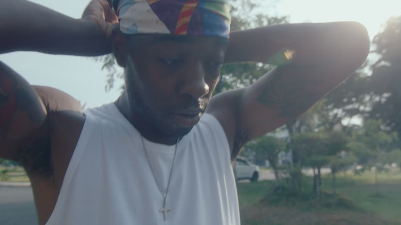 Young Black Man Putting On Headband before Playing Basketball