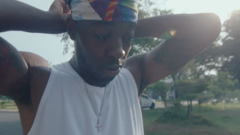 young black man putting on headband before playing basketball