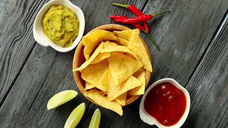 nachos servidos con salsas en la mesa