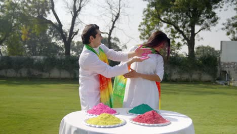 beautiful indian couple celebrating holi festival