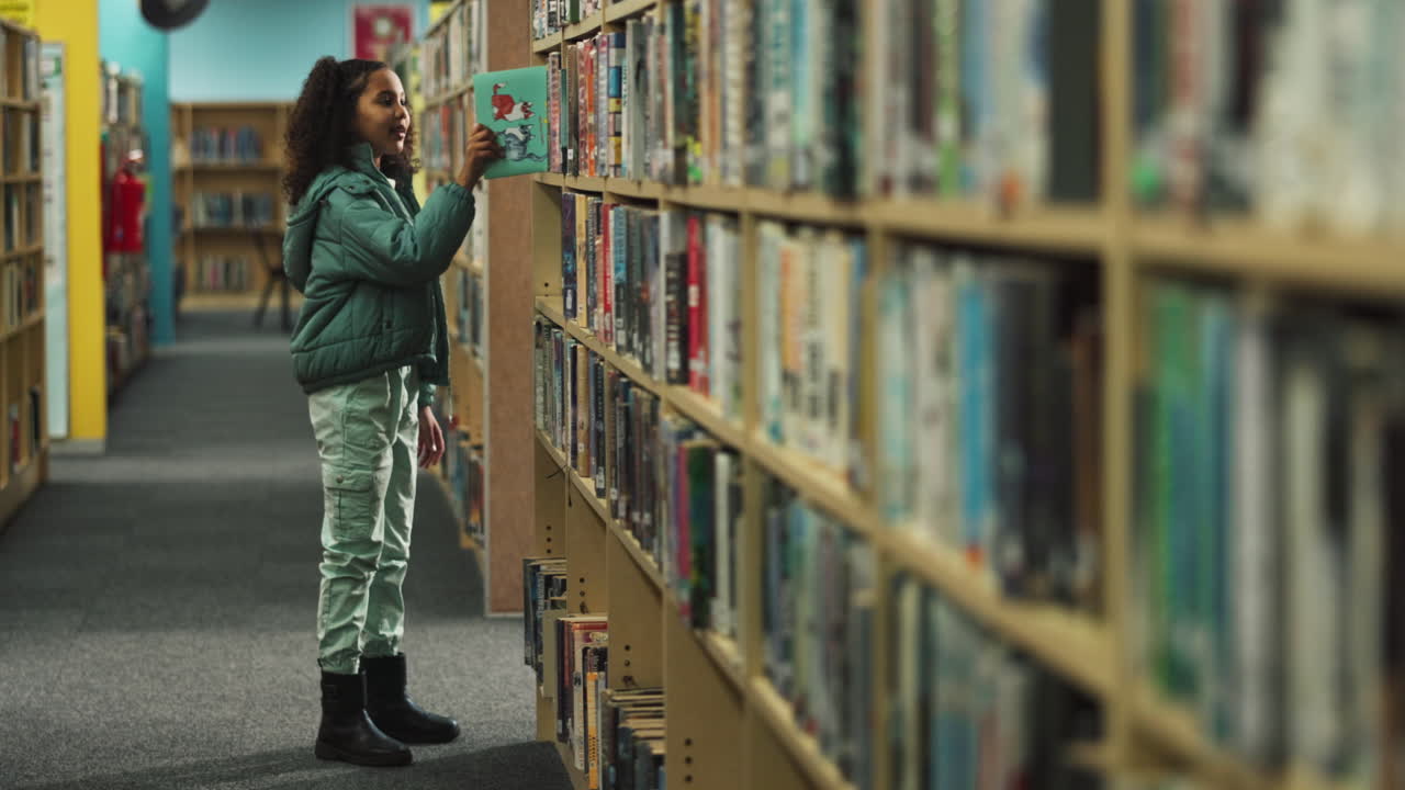 A child selecting a book in a library