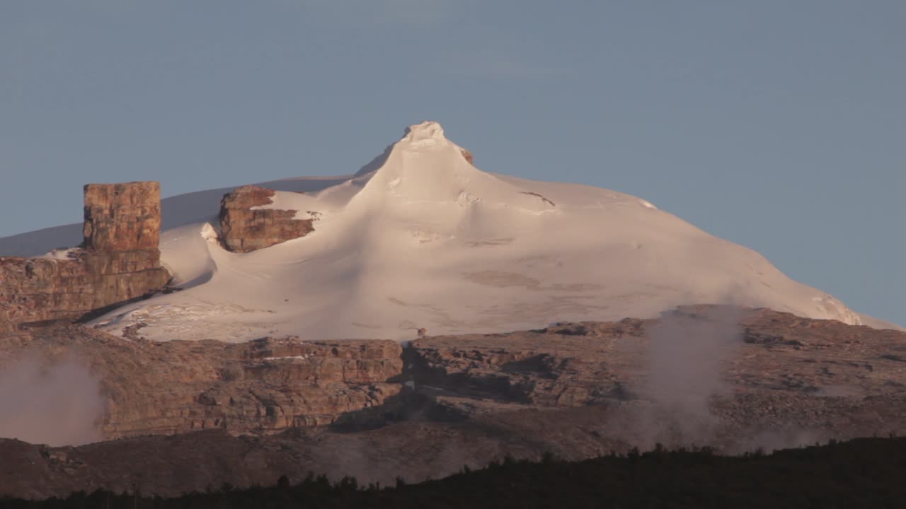 Snow-Capped Mountain Peak with Rocky Cliffs