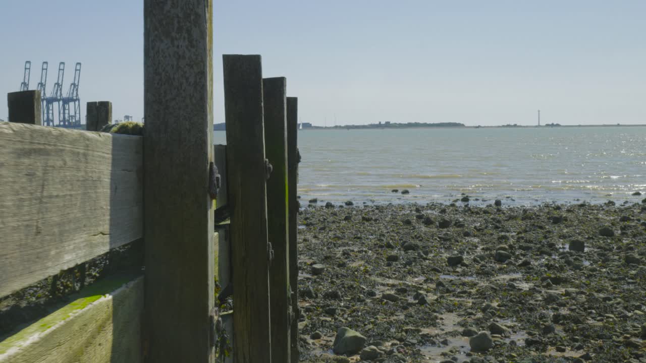 부두 의 잔해 뒤 에서 물류 터미널 을 바라보는 것