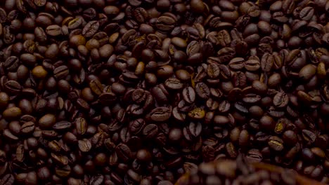 4k footage. 4096x2304p.fragrant coffee beans are roasted in a frying pan, smoke comes from coffee beans. the whole composition scrolls slowly around the camera. scoop stir coffee beans.
