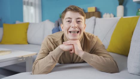 teenager with braces smiles at camera.