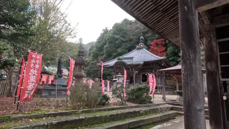 red banners flutter at a serene japanese shrine