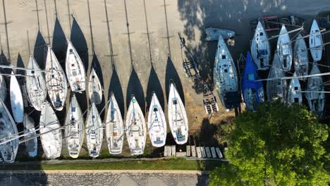 moving leftward from direct aerial over sailboats in disuse