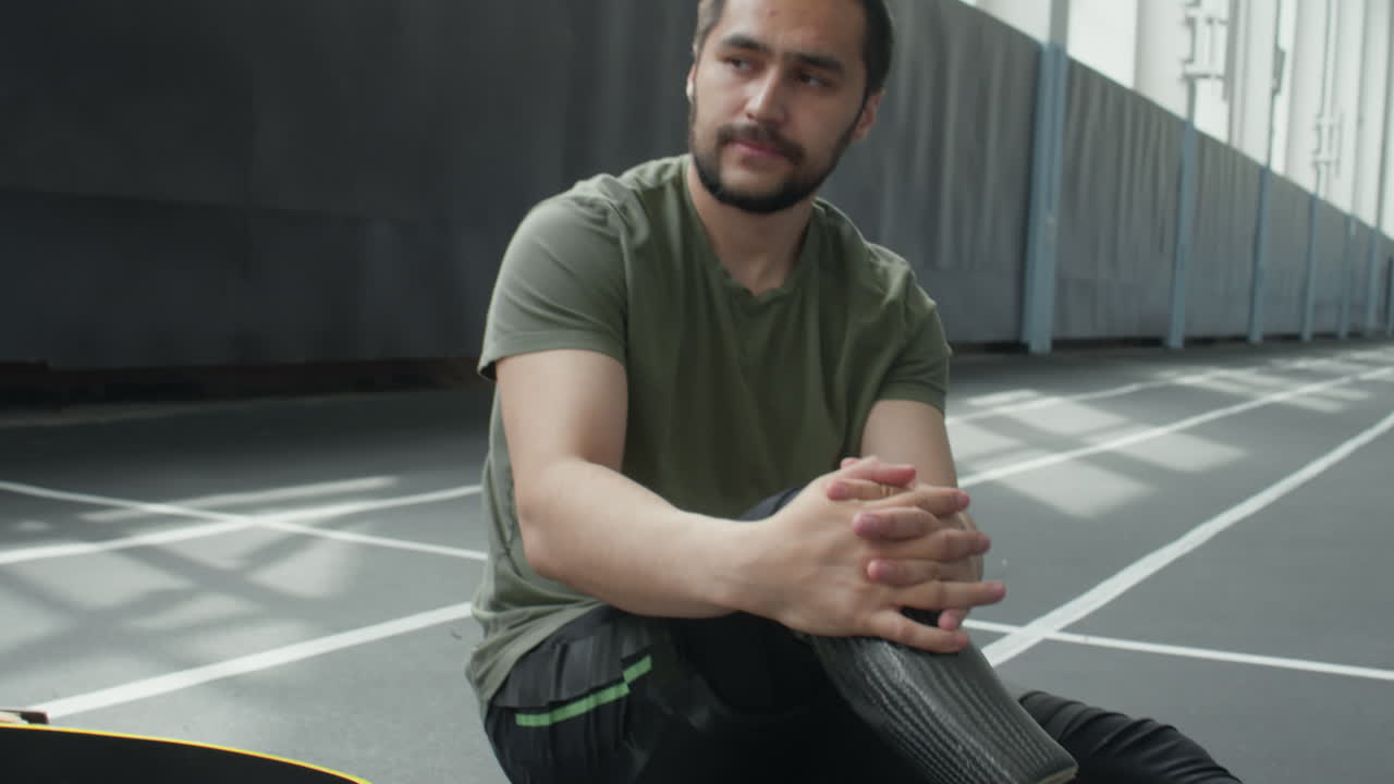 Athlete with Prosthetic Leg Resting after Training