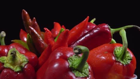 vegetarian healthy food, composition of vegetables,  rotation of a basket with peppers on a black background