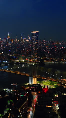 Lightening sparkles in the sky above beautiful New York. Night metropolis panorama from aerial view. Vertical video