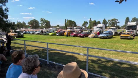 people watching a vintage car show outdoors