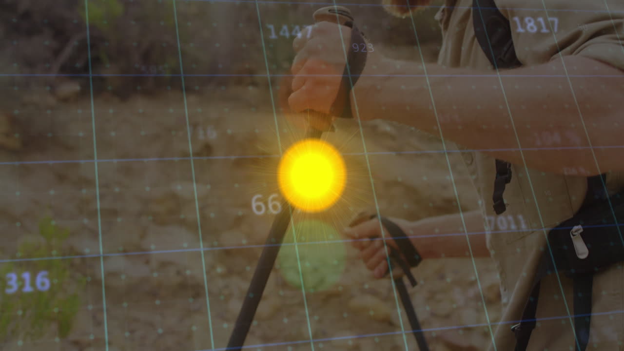 male hiker gripping trekking poles on rocky trail, displaying tech grid data and sun icon