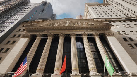 Stock-Exchange-Building-Located-On-Wall-Street-In-New-York-On-The-Building-Hangs-A-Poster