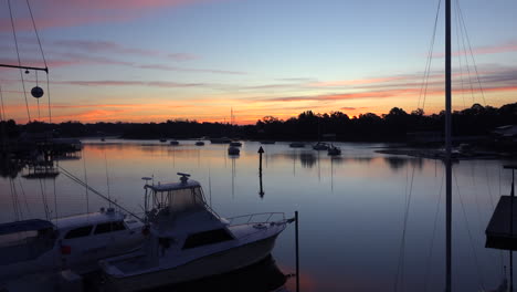 a harbor with boats at sunset