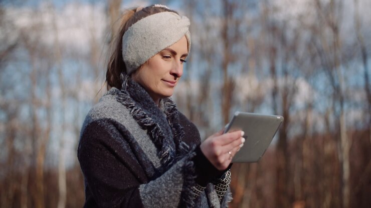 Woman Using Digital Tablet Outdoors On A Trip 2