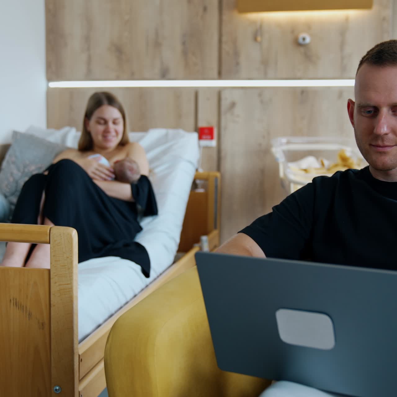 Modern pregnant hospital room. Lady with newborn baby in nursery ward