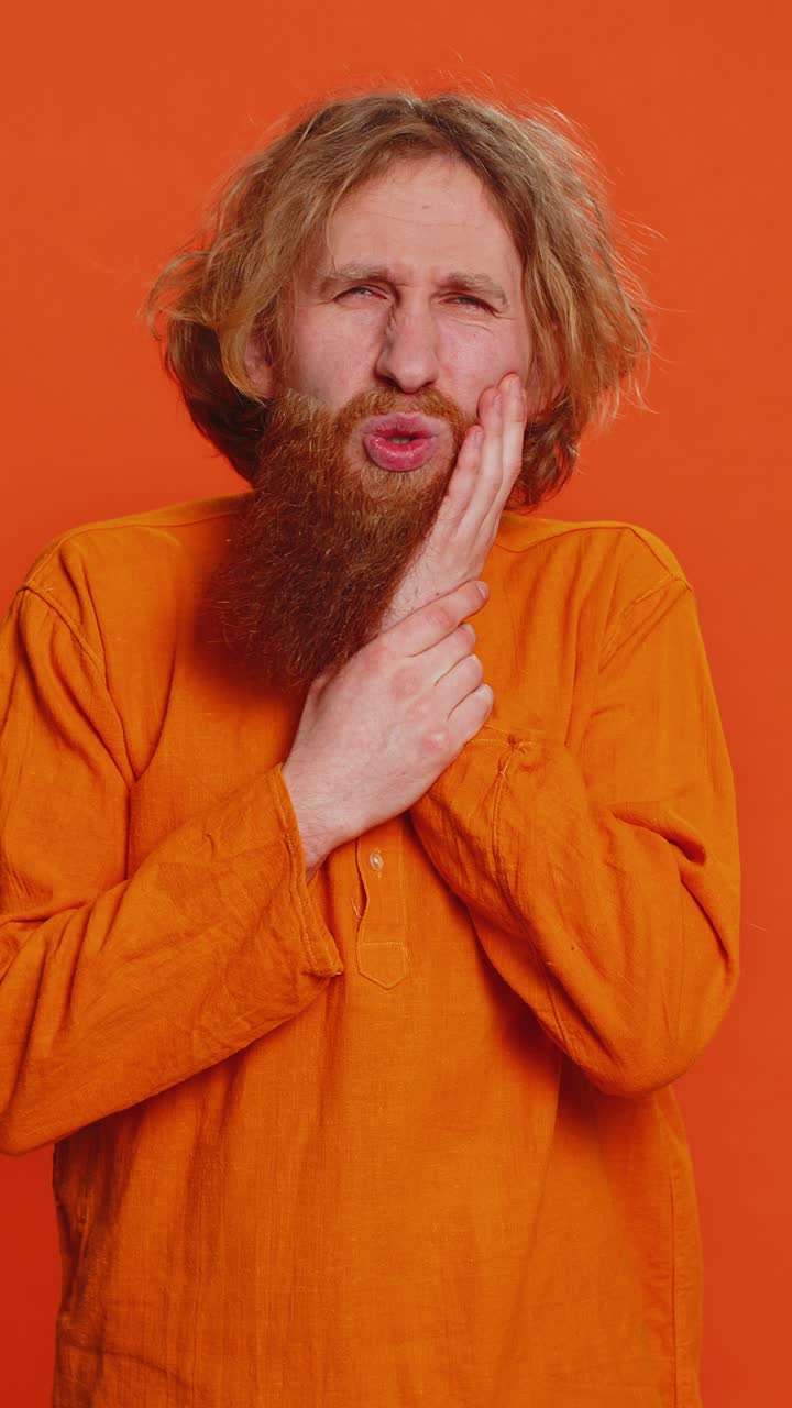 Caucasian man touching cheek closing eyes with expression of terrible suffer from painful toothache