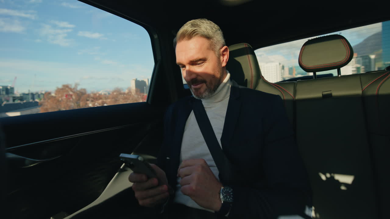 Businessman Using Smartphone in Car