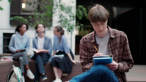 caucasian thoughtfull boy in university campus.