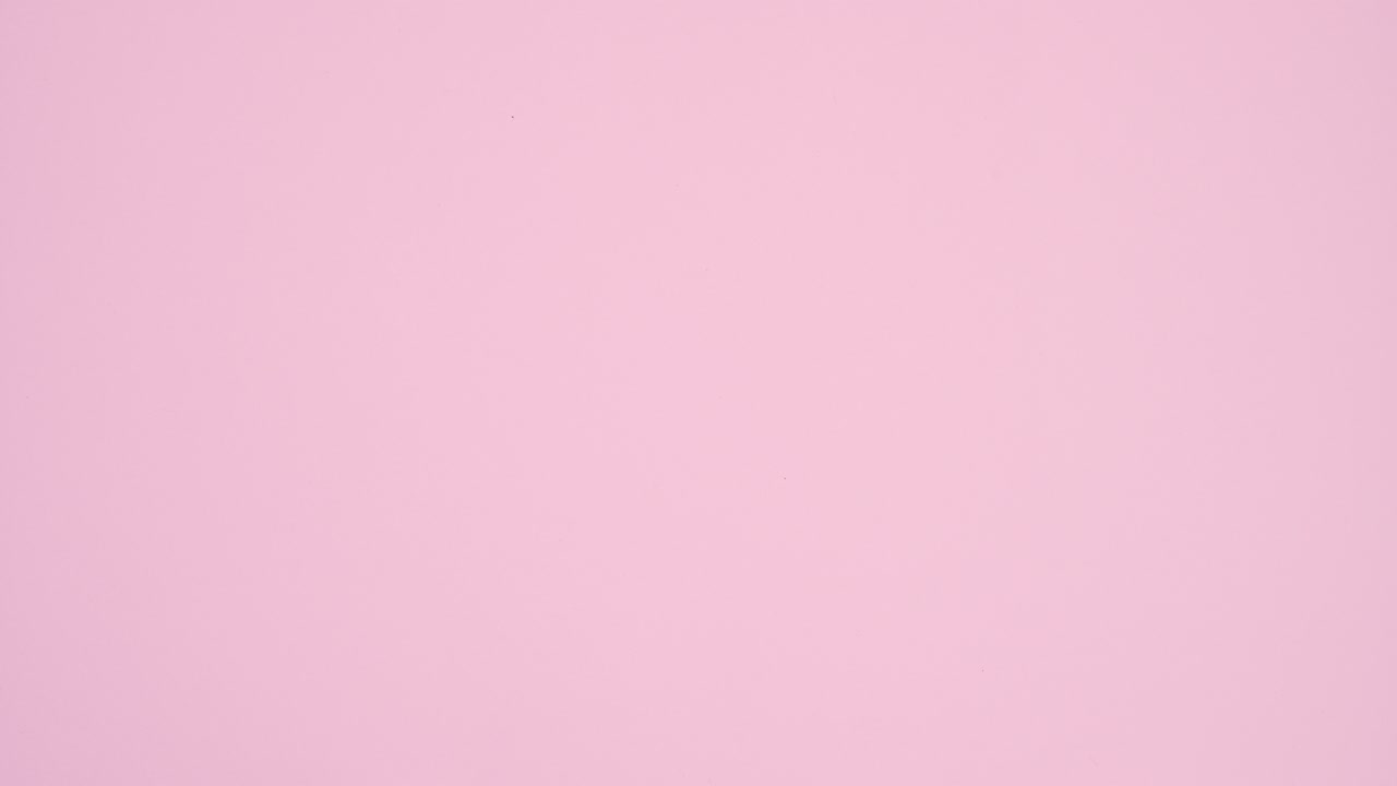 Romantic Valentine's day red hearts appear around Love on pastel pink theme. Stop motion