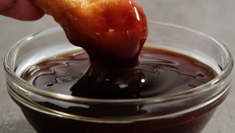 dipping fried chicken in sauce