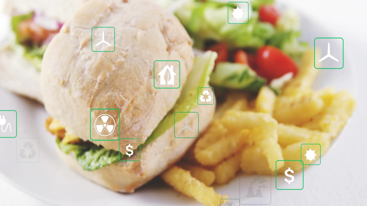Icone ecologiche che emergono dai bordi, fluttuando su un panino e patatine fritte, mostrando l'impatto ecologico mentre la telecamera zooma.