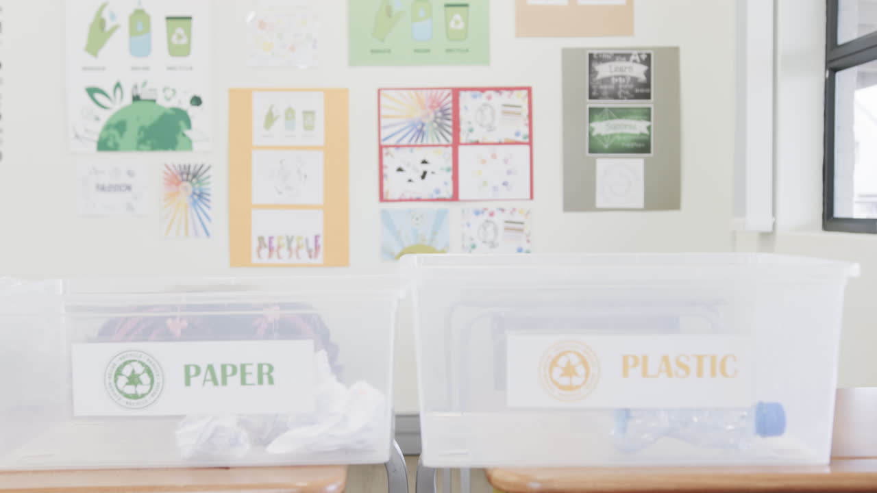 Recycling bins for paper and plastic in classroom promoting environmental awareness, at school