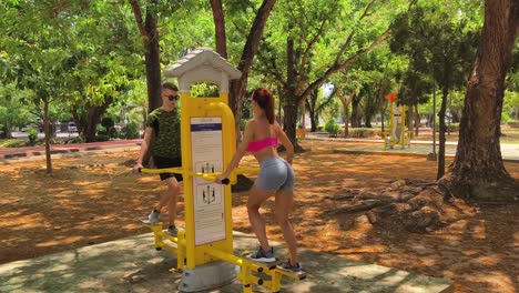 couple exercising at outdoor fitness park